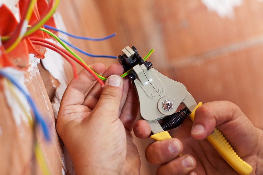 an electrician working on a wiring fault