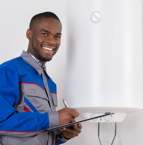 new-water-heater-min An electrician examining a new water heater installation